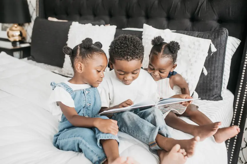 image of children looking a photo book