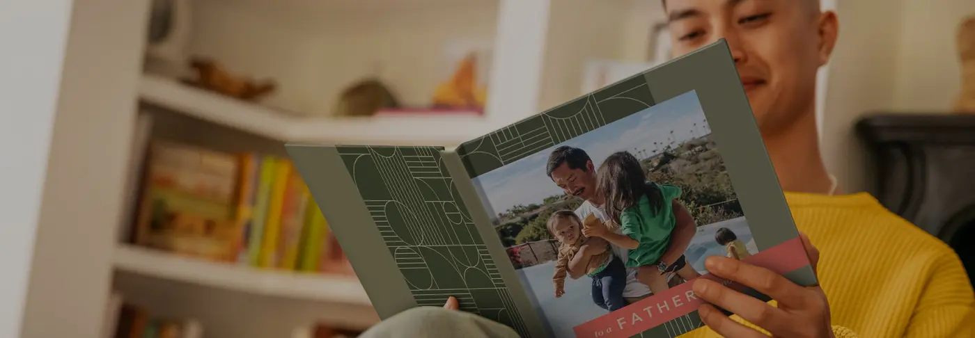 A father holding a photo book