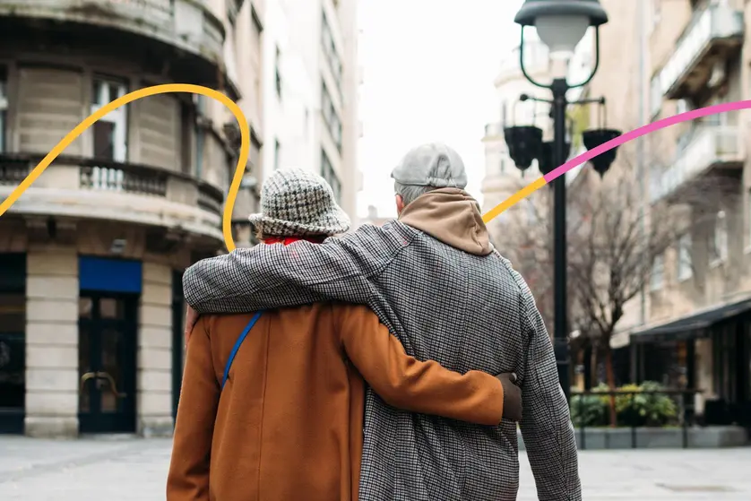 An image of a couple walking arm in arm down a city street, celebrating their 50th wedding anniversary.