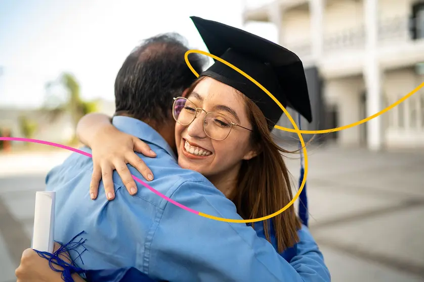 A daughter hugs her father on graduation day.