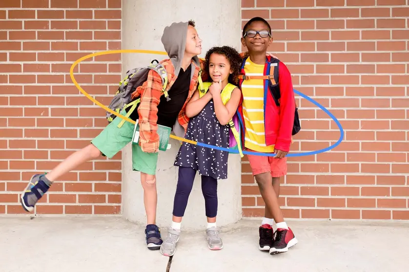 An image of children posing for the first day of school pictures.