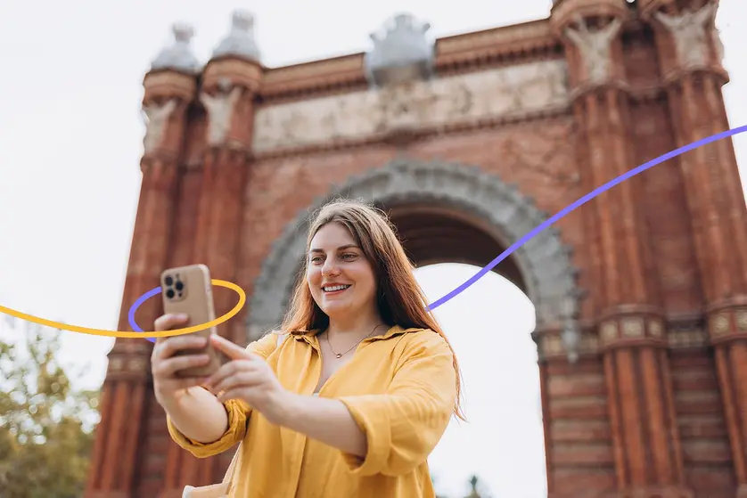 A person taking a photo using a cell phone, preferably seeing the grid on the person’s phone to help with framing.