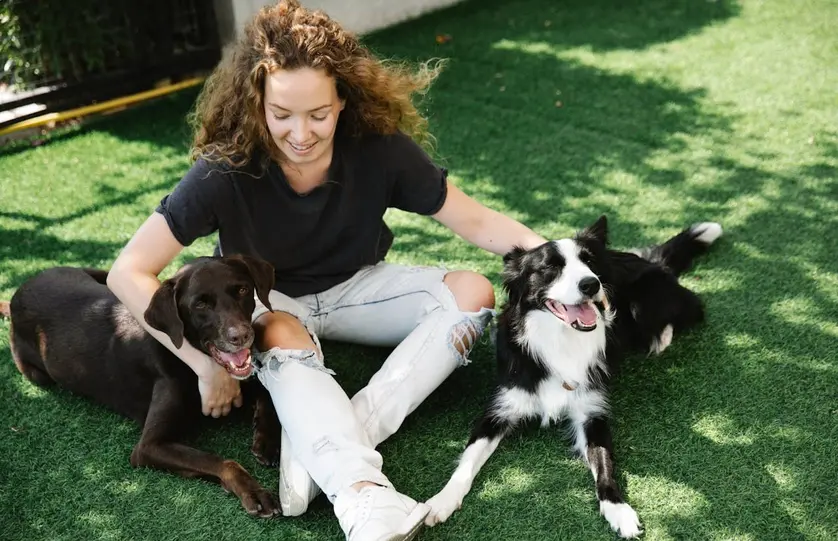 a lady being affectionate with her dogs