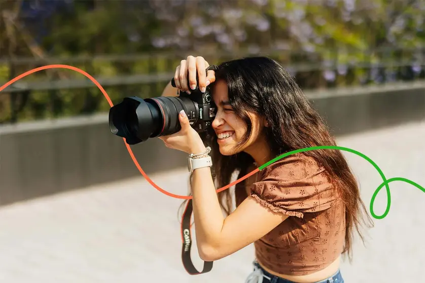 A person takes a photo outside as part of a photo scavenger hunt.