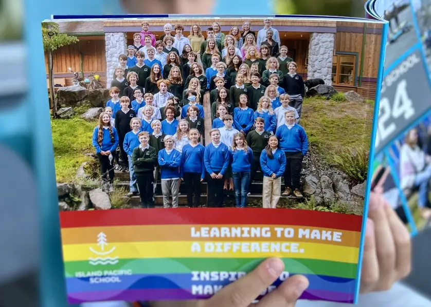 Students featured in a colorful school yearbook created with Mixbook, showcasing a full class group photo.