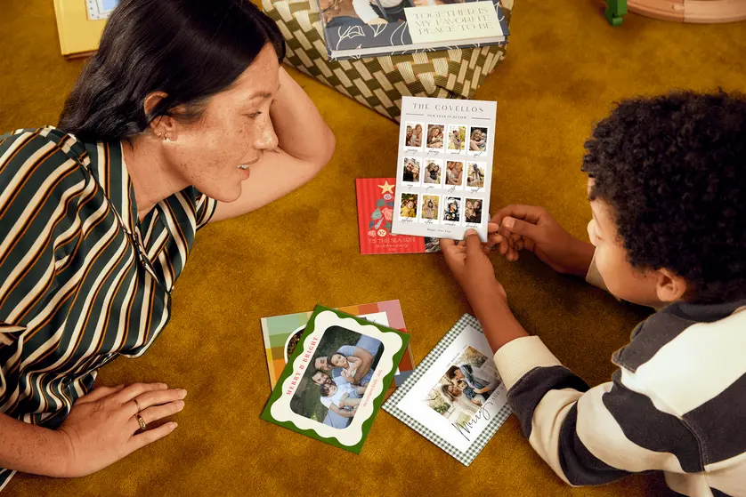 mother and child holding holiday cards