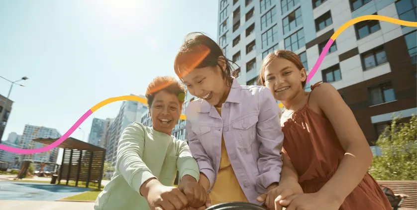 Children laughing together outside on a sunny school day